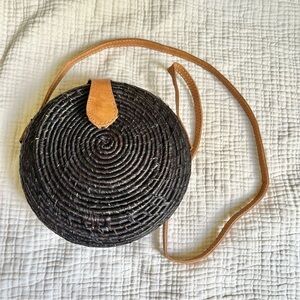 Shebobo | Round Black Woven Raffia Crossbody Clamshell Bag with Tan Strap